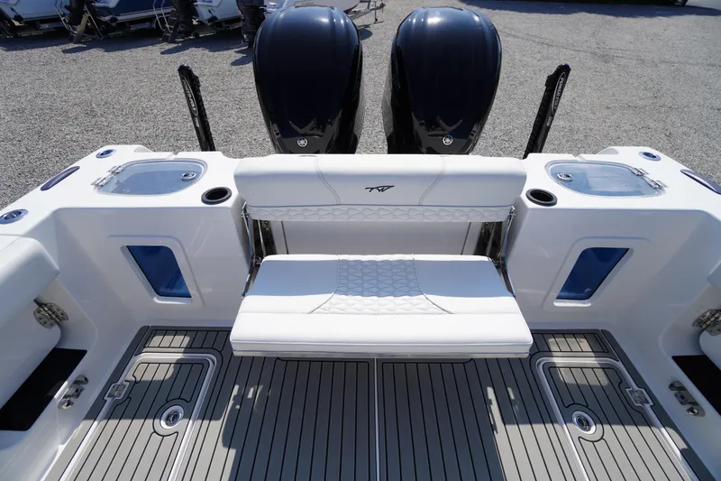 Slide: The Image of 2026 Tidewater 302 CC Adventure boat interior with dual engines and seating. - 63