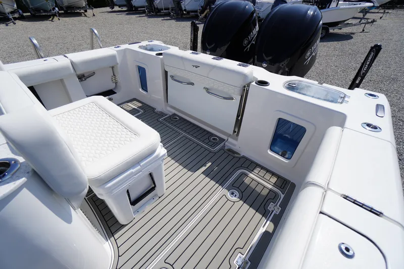 Slide: The Image of 2026 Tidewater 302 CC Adventure boat interior with seating and dual Yamaha engines. - 65