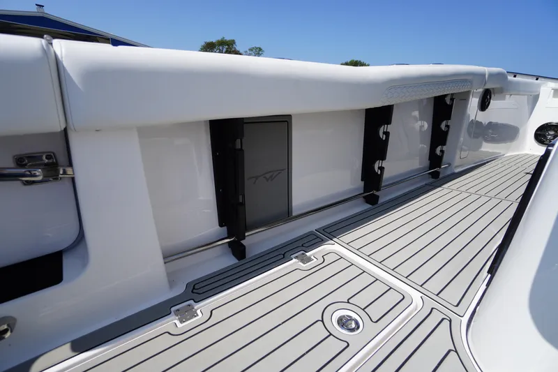 Slide: The Image of 2026 Tidewater 302 CC Adventure boat interior with sleek deck design and storage features. - 67