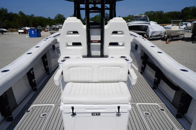 Slide: The Image of 2026 Tidewater 302 CC Adventure boat interior with cushioned seating and deck view. - 68
