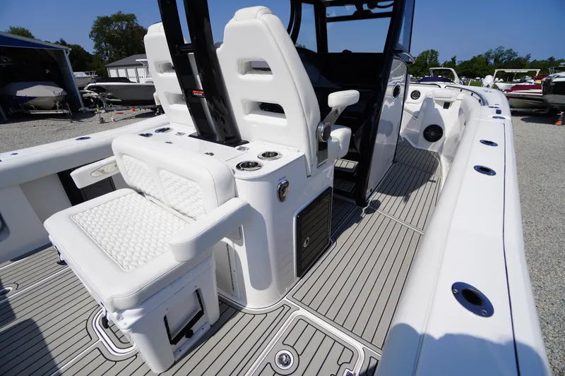 Slide: The Image of 2026 Tidewater 302 CC Adventure boat interior with white seating and sleek design. - 69