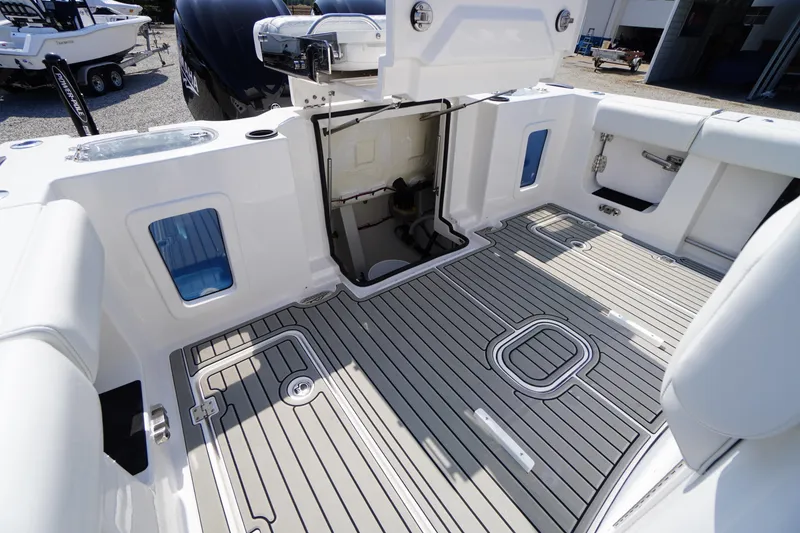 Slide: The Image of 2026 Tidewater 302 CC Adventure boat interior with open hatch and sleek deck design. - 77