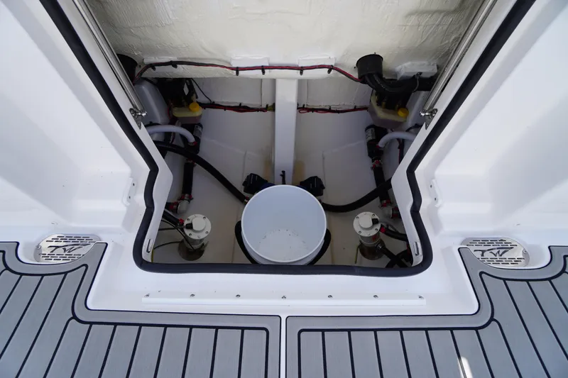 Slide: The Image of 2026 Tidewater 302 CC Adventure boat storage compartment with mechanical components. - 78