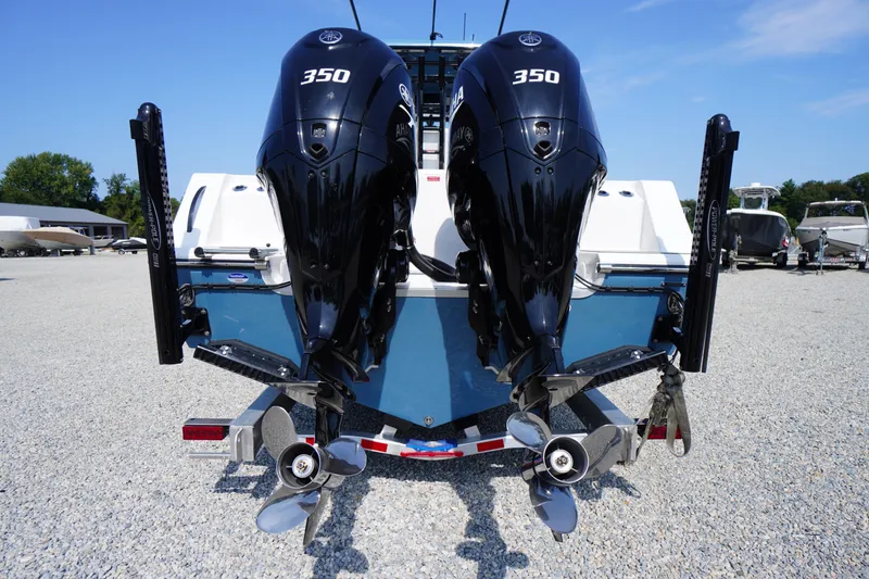 Slide: The Image of 2026 Tidewater 302 CC Adventure boat with dual 350 horsepower engines, parked on gravel. - 87