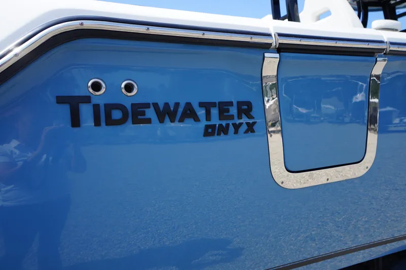 Slide: The Image of 2026 Tidewater 302 CC Adventure boat with blue exterior and Onyx branding. - 89
