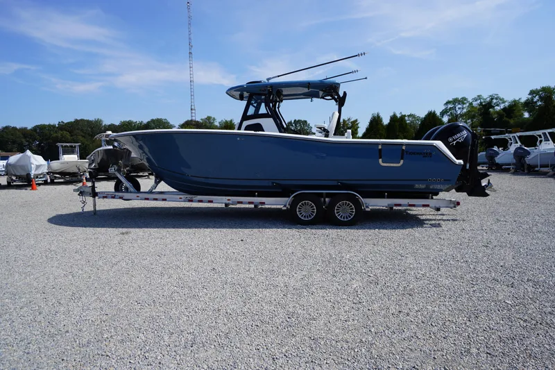 Slide: The Image of 2026 Tidewater 302 CC Adventure boat on trailer in outdoor lot. - 94
