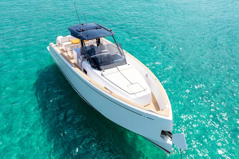 Slide: The Image of 2025 Pardo Yachts P38 luxury boat on clear turquoise water. - 12