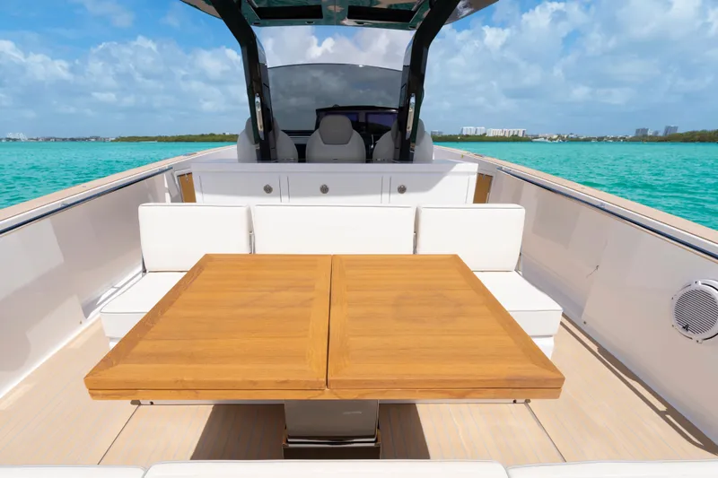 Slide: The Image of 2025 Pardo Yachts P38 luxury yacht interior with seating and table on turquoise water. - 17