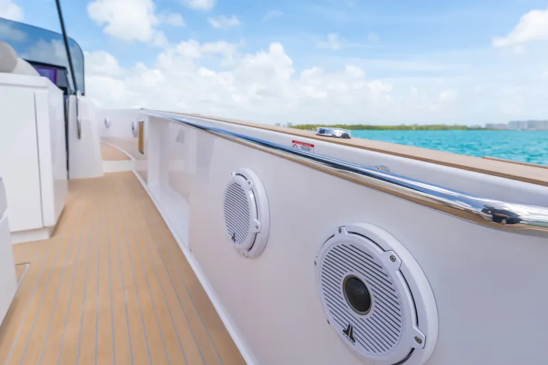 Slide: The Image of 2025 Pardo Yachts P38 cruising on clear blue waters under a sunny sky. - 23