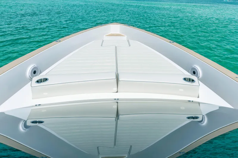 Slide: The Image of 2025 Pardo Yachts P38 deck with cushioned seating, surrounded by turquoise water. - 41