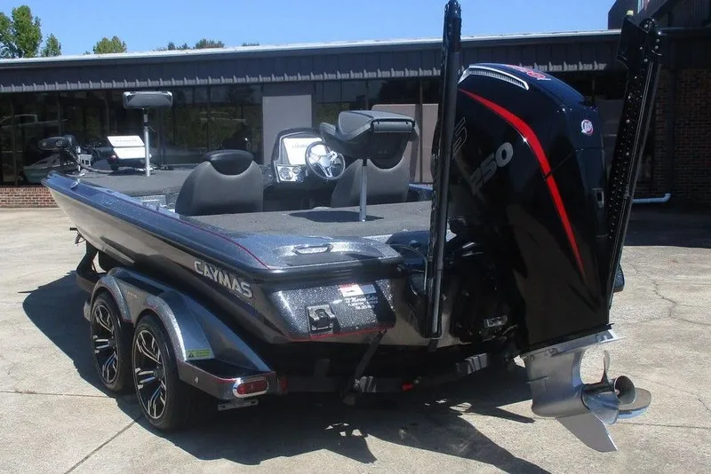 Slide: The Image of 2023 Caymas CX21 Pro boat with powerful engine and sleek design, parked outdoors. - 3