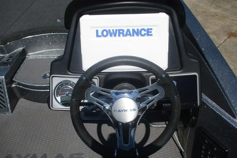 Slide: The Image of 2023 Caymas CX21 Pro dashboard with Lowrance display and steering wheel. - 6