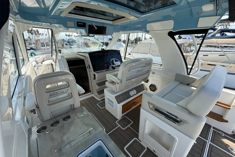 Slide: The Image of Interior of 2023 Boston Whaler 380 Realm, featuring luxurious seating and modern helm controls. - 12
