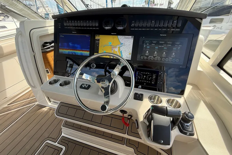 Slide: The Image of 2023 Boston Whaler 380 Realm helm with advanced navigation displays and controls. - 18