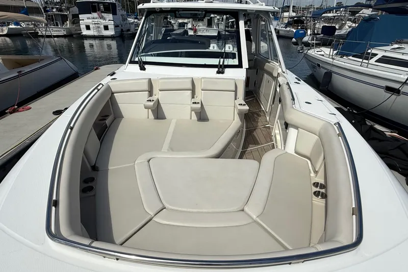 Slide: The Image of 2023 Boston Whaler 380 Realm boat with spacious seating at marina. - 22