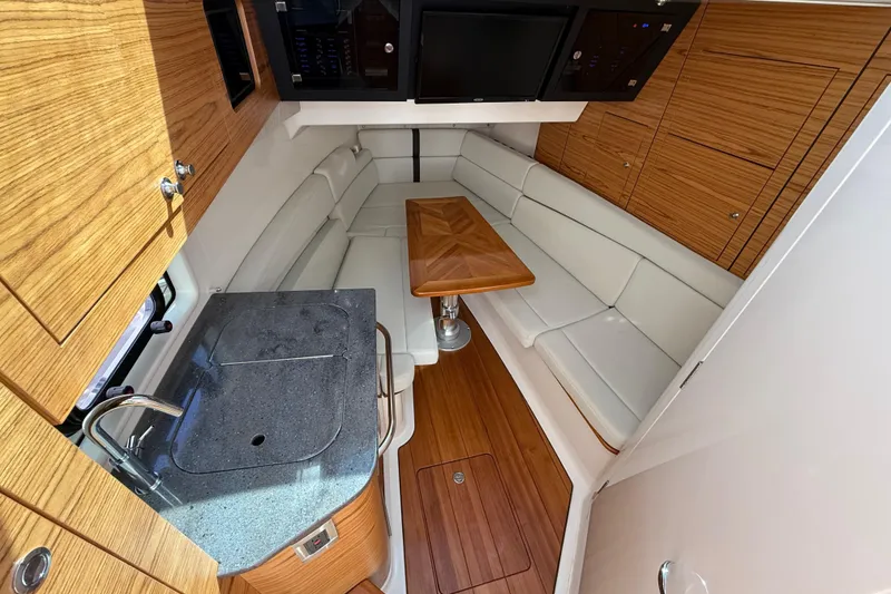 Slide: The Image of Luxurious interior of 2023 Boston Whaler 380 Realm with seating and kitchenette. - 24
