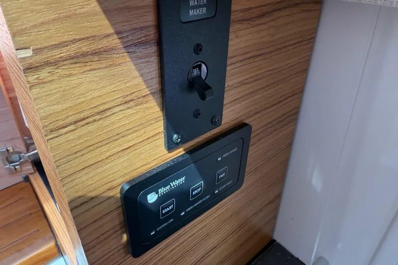 Slide: The Image of Control panel on 2023 Boston Whaler 380 Realm boat, featuring water maker switch. - 30