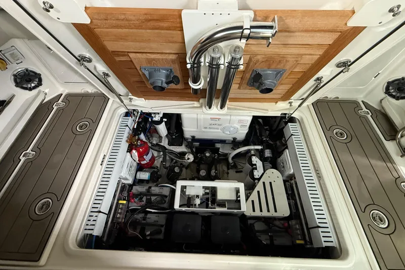 Slide: The Image of Engine compartment of 2023 Boston Whaler 380 Realm, showcasing equipment and storage layout. - 31