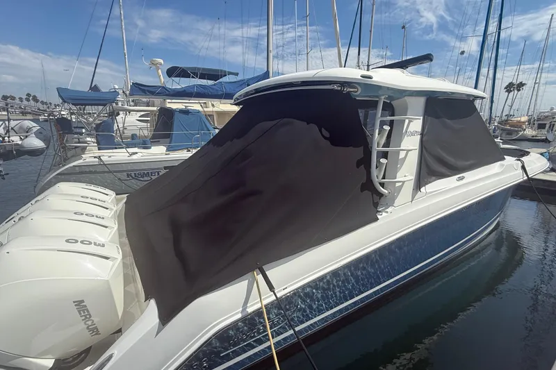 Slide: The Image of 2023 Boston Whaler 380 Realm docked with covered windows and powerful Mercury engines. - 33