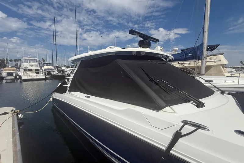 Slide: The Image of 2023 Boston Whaler 380 Realm docked at marina under clear blue sky. - 36