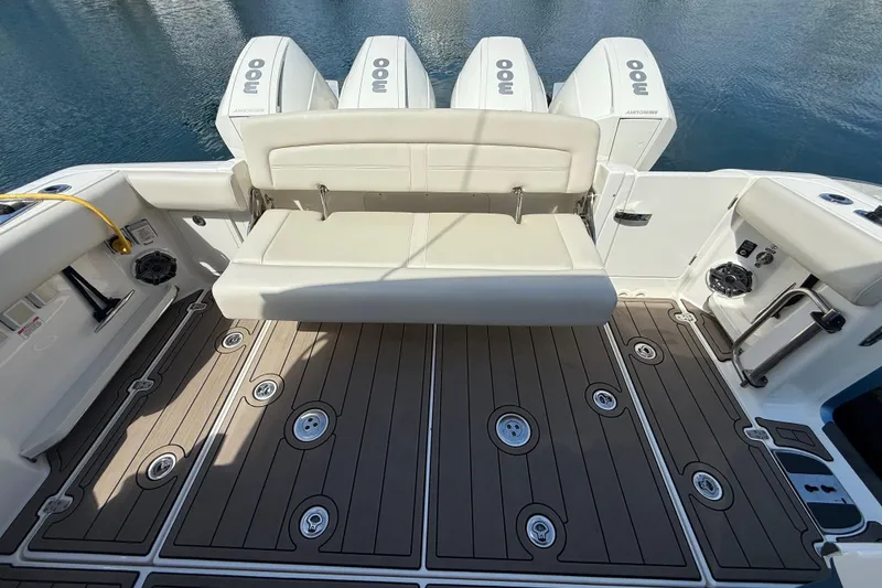 Slide: The Image of 2023 Boston Whaler 380 Realm boat deck with seating and four outboard engines. - 8
