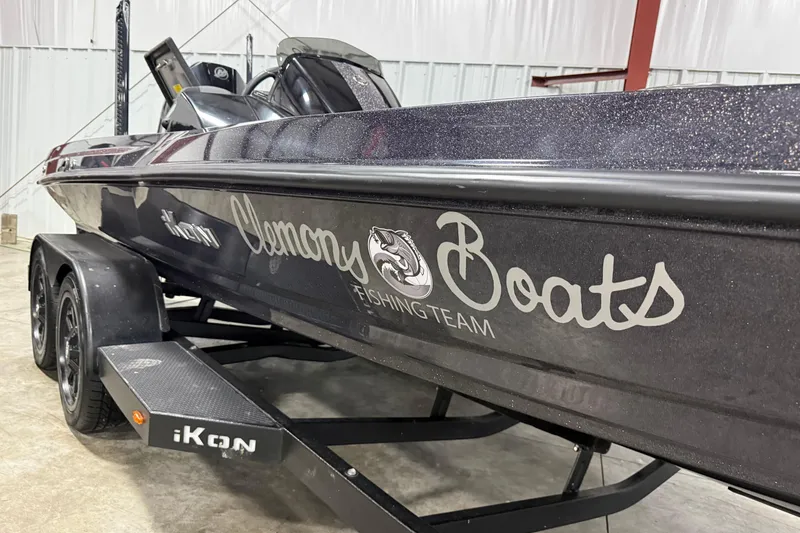 Slide: The Image of 2024 iKon LX21 fishing boat with Clemons Boats logo in a garage setting. - 2