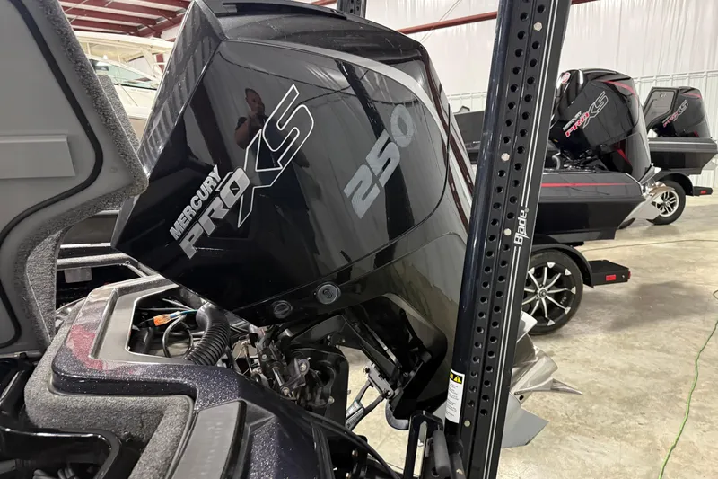 Slide: The Image of 2024 iKon LX21 with Mercury Pro XS 250 outboard engine in a showroom setting. - 3