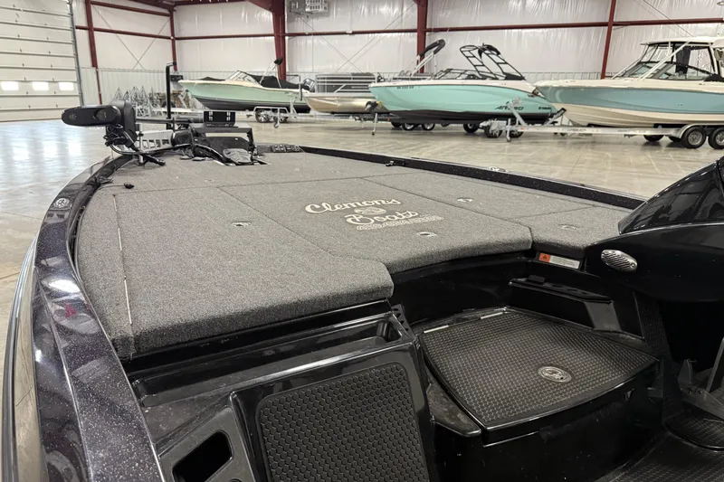 Slide: The Image of 2024 iKon LX21 boat interior with Clemons Boats branding in a showroom. - 6