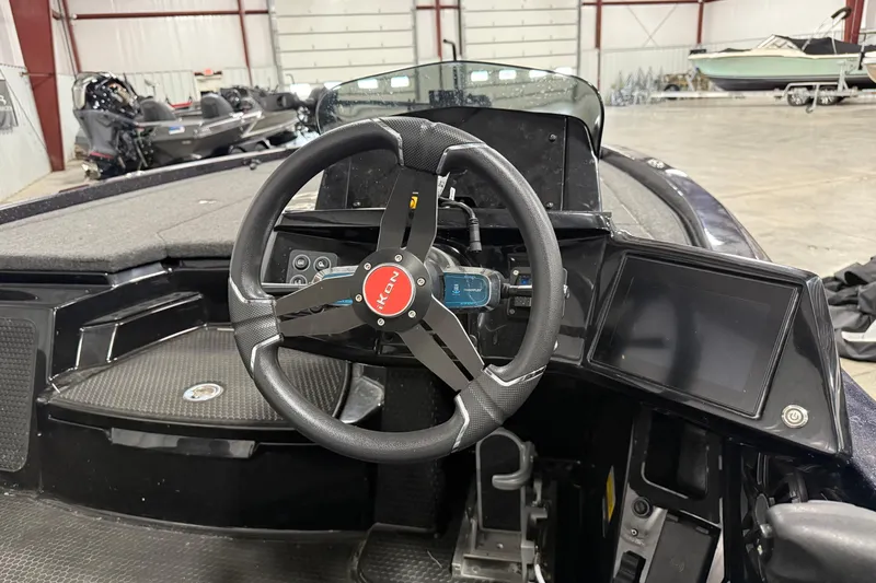 Slide: The Image of Steering wheel of 2024 iKon LX21 boat in a showroom setting. - 9