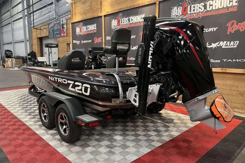Slide: The Image of 2019 Nitro Z20 Pro boat on display in showroom with dual axle trailer. - 2