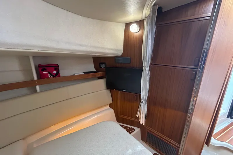 Slide: The Image of 2023 Ranger Tugs R-31 CB cabin interior with wood paneling and seating area. - 12