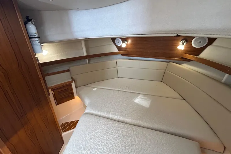 Slide: The Image of 2023 Ranger Tugs R-31 CB cabin interior with cozy seating and ambient lighting. - 13