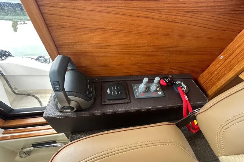 Slide: The Image of 2023 Ranger Tugs R-31 CB helm controls with joystick and throttle levers. - 15