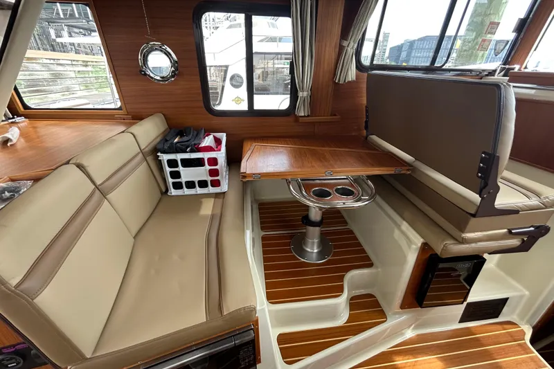 Slide: The Image of Interior of 2023 Ranger Tugs R-31 CB with seating and wooden table. - 17