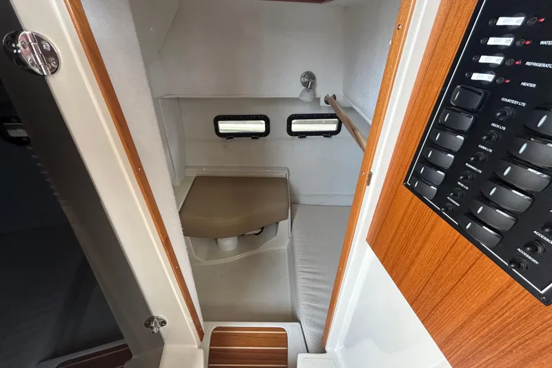 Slide: The Image of 2023 Ranger Tugs R-31 CB interior cabin with control panel and seating area. - 18