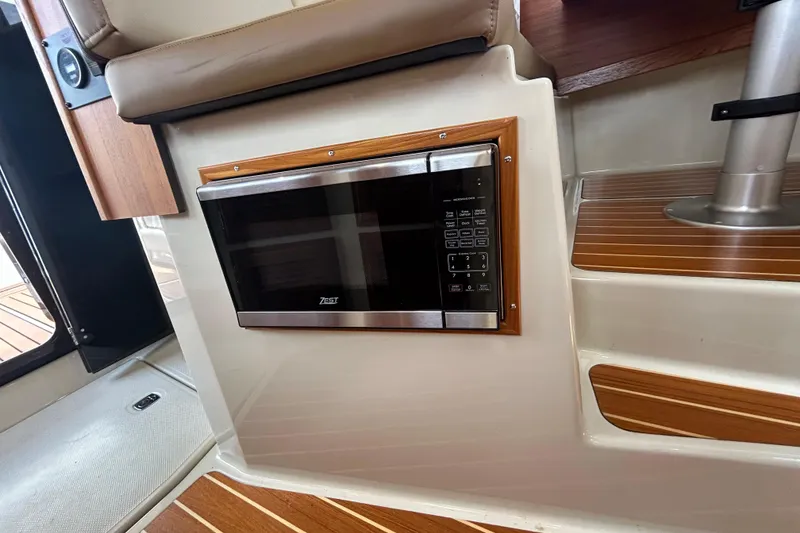 Slide: The Image of Microwave installed in 2023 Ranger Tugs R-31 CB boat interior with wood accents. - 9