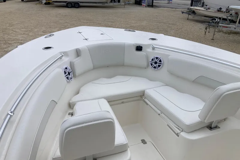 Slide: The Image of 2026 Key West 260 Center Console boat interior with white seating and speakers. - 10
