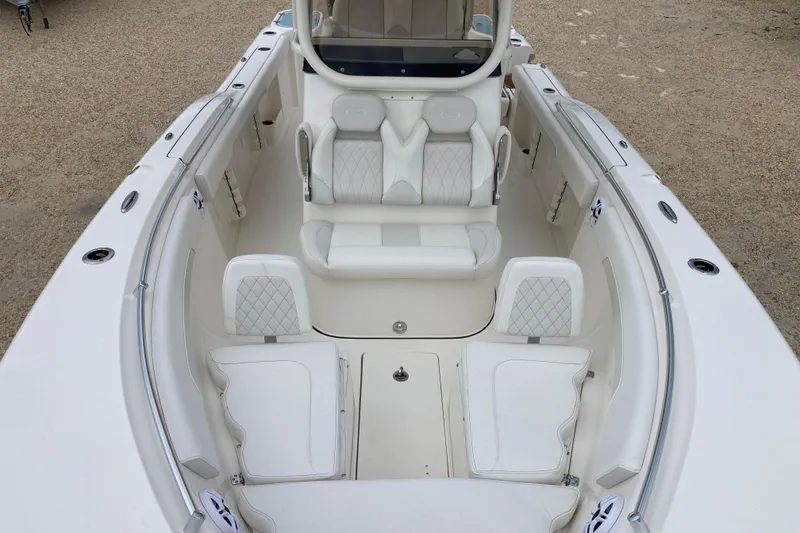 Slide: The Image of 2026 Key West 260 Center Console boat interior with white seating and spacious layout. - 11