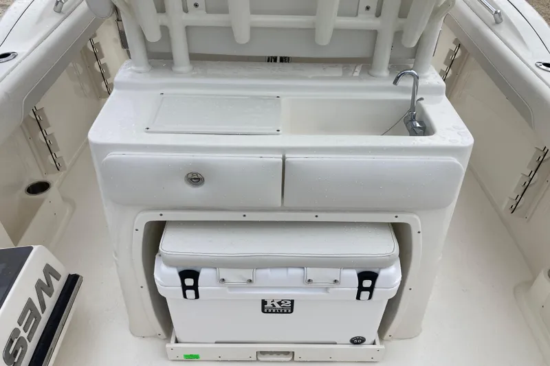 Slide: The Image of 2026 Key West 260 Center Console boat interior with sink and cooler. - 4