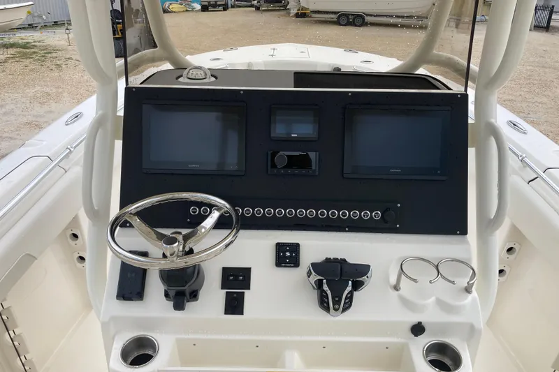 Slide: The Image of 2026 Key West 260 Center Console boat dashboard with steering wheel and dual screens. - 5