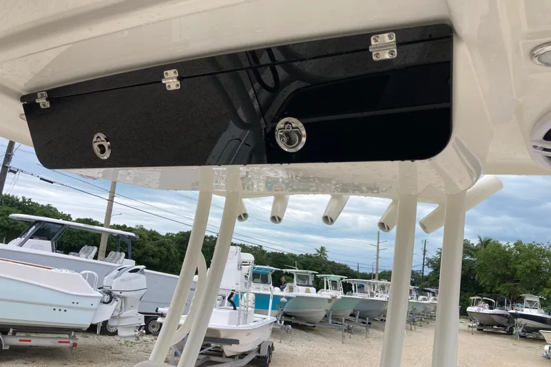 Slide: The Image of 2026 Key West 260 Center Console boat with sleek black storage compartment and rod holders. - 7