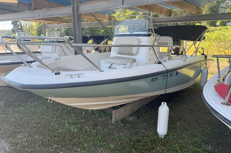 The Image of 2017 Boston Whaler 180 Dauntless boat in storage, side view with visible registration number. - 0