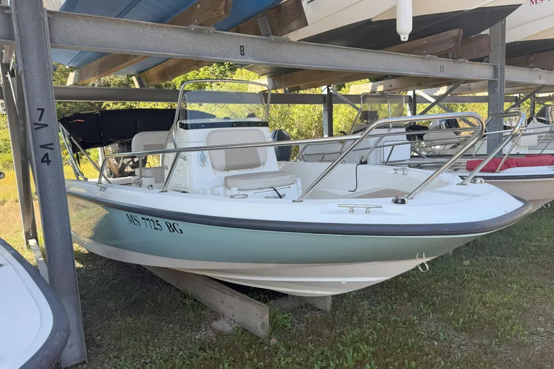 Slide: The Image of 2017 Boston Whaler 180 Dauntless boat stored on a rack outdoors. - 3