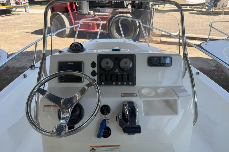Slide: The Image of 2017 Boston Whaler 180 Dauntless boat console with steering wheel and controls. - 4