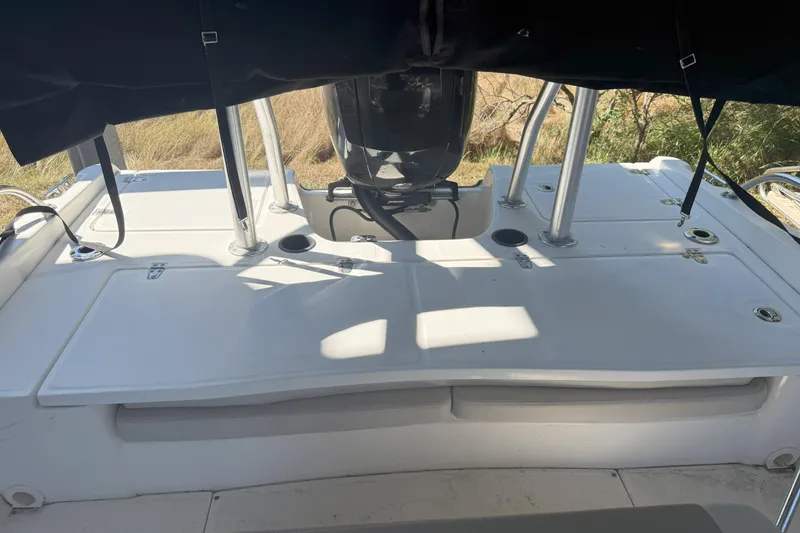 Slide: The Image of 2017 Boston Whaler 180 Dauntless boat deck with motor and seating area. - 8