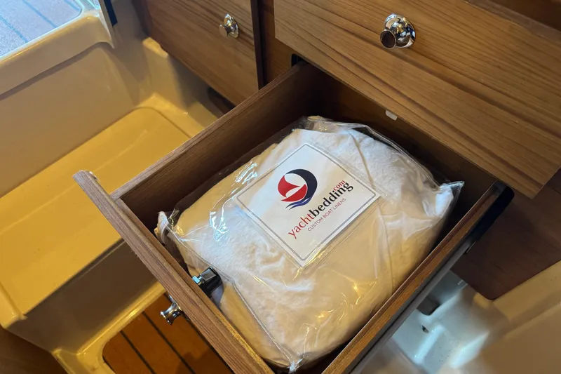 Slide: The Image of Open drawer in 2025 Ranger Tugs R-27 with yacht bedding package inside. - 20