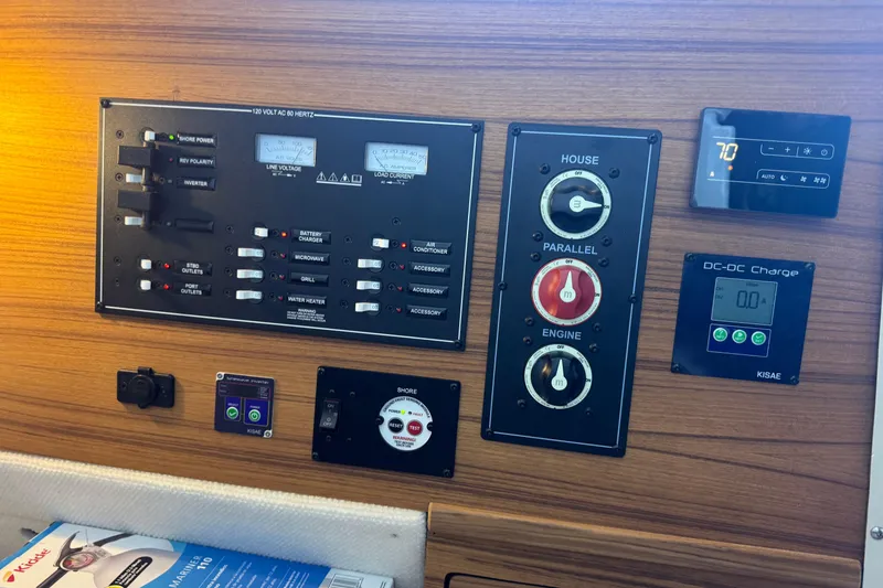 Slide: The Image of Control panel of 2025 Ranger Tugs R-27 boat with various switches and gauges. - 23