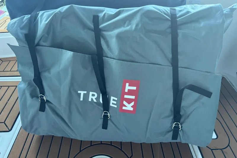 Slide: The Image of Gray True Kit bag on Ranger Tugs R-27, 2025 model, wooden deck background. - 31