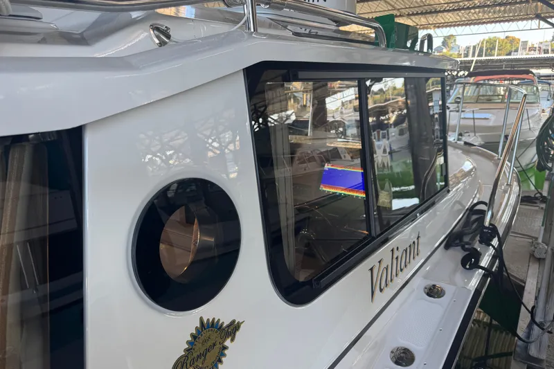 Slide: The Image of 2025 Ranger Tugs R-27 boat docked, showcasing sleek design and modern features. - 33