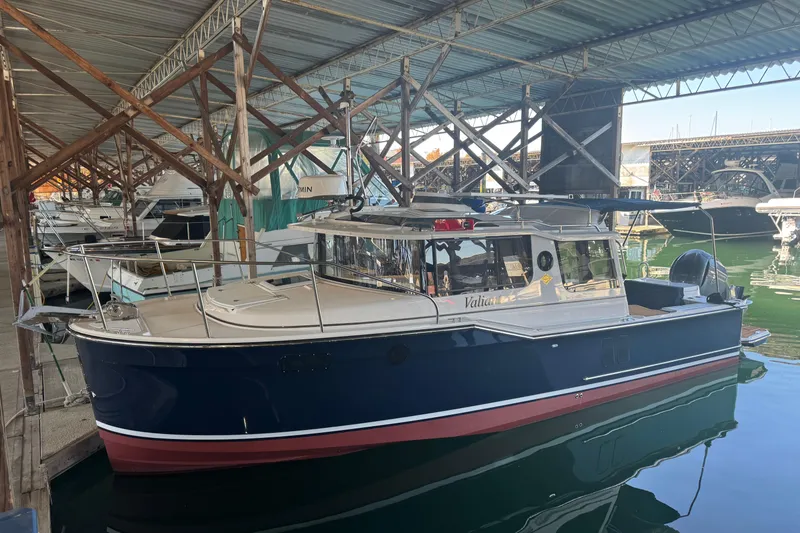 Slide: The Image of 2025 Ranger Tugs R-27 boat docked in a covered marina. - 36